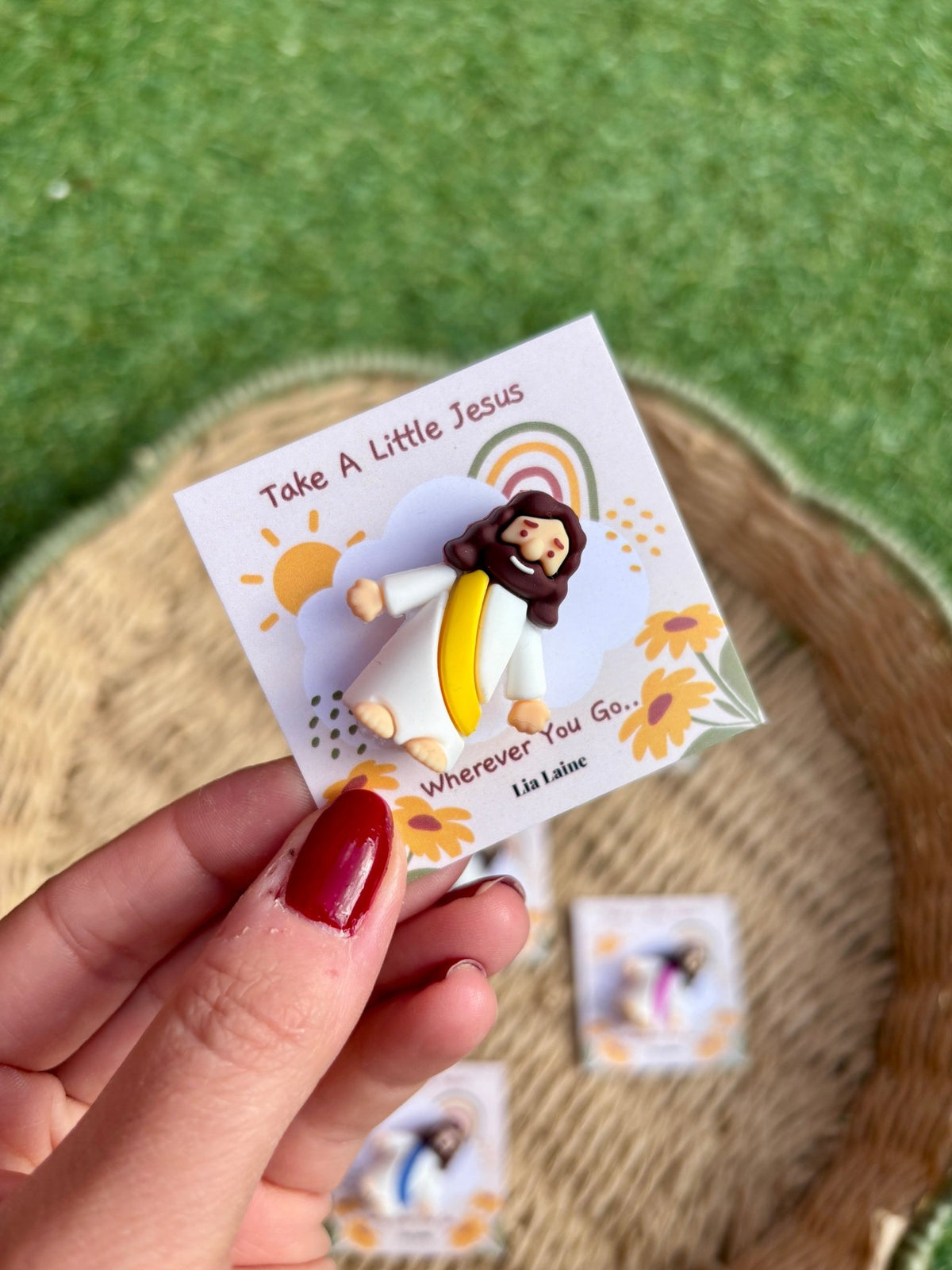 Jesus Pocket Card, yellow mini Jesus figurine on a bright backing card with other colours and grass in the background